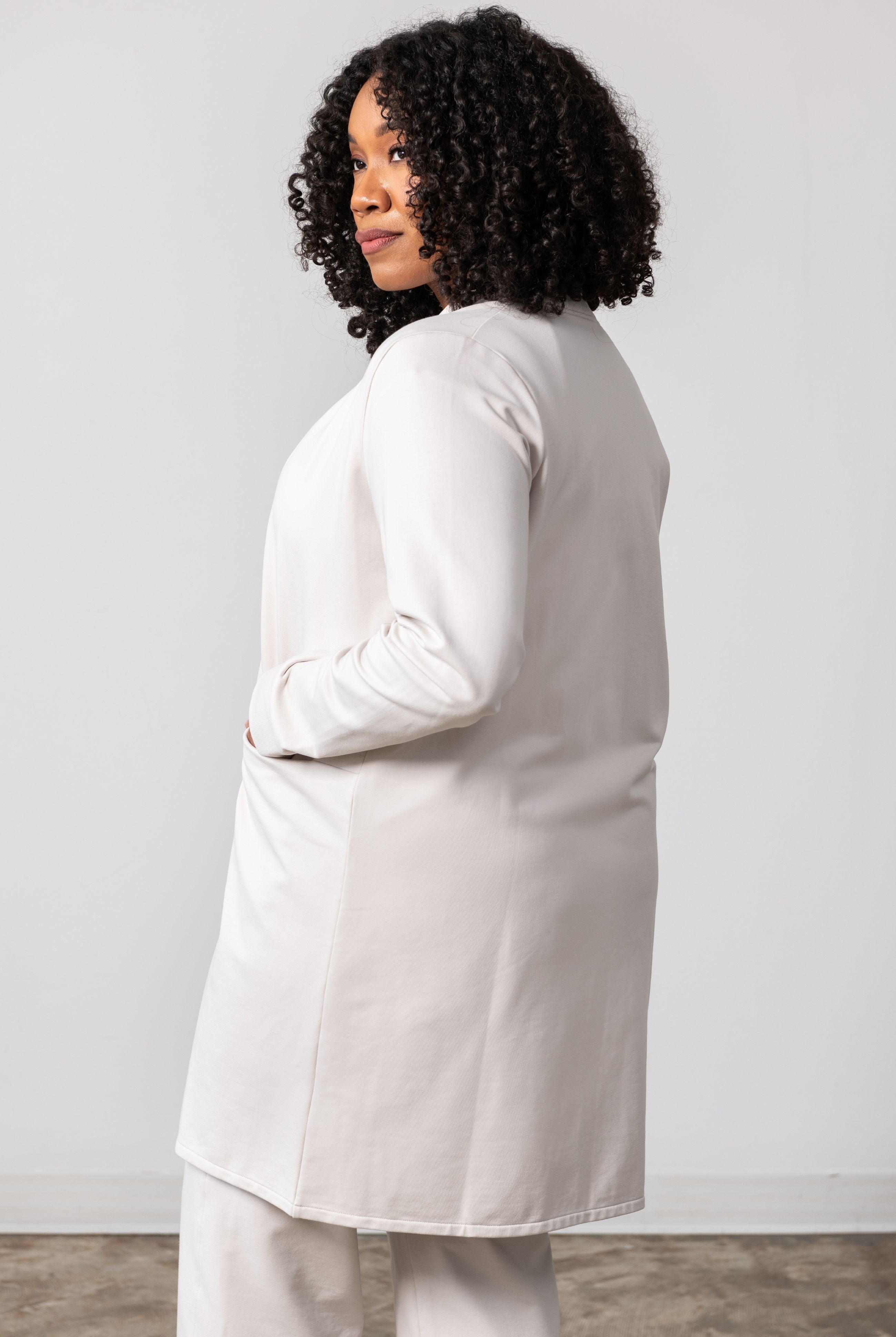 Woman shown wearing light beige cardigan